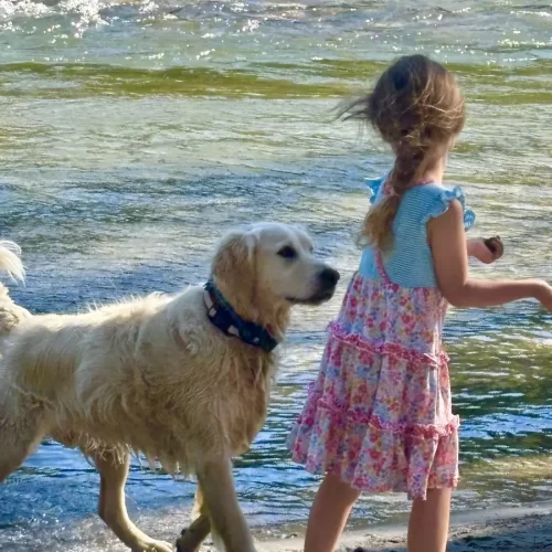 Drew and Spirit have fun on the lake's shore.